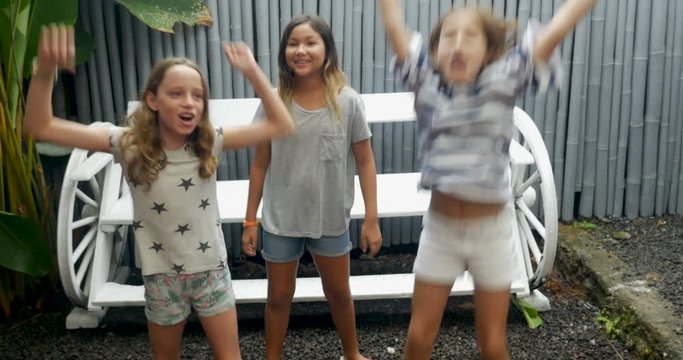 Three young diverse racial group of young pre teen girls dancing together