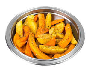 Raw potato slices and pumpkin with spices in metal bowl