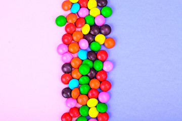 Small colored candy on bright background
