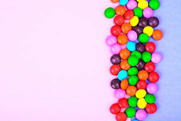 Small colored candy on bright background