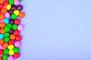 Obraz premium Small colored candy on bright background