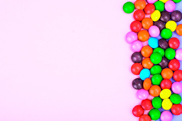 Small colored candy on bright background