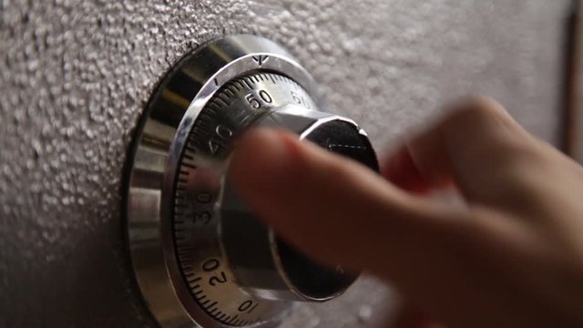 Locking and then opening a safe - close up on dial