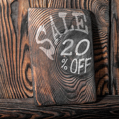 The inscription sale on a wooden background.