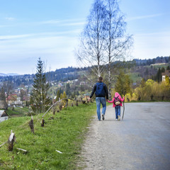 Fototapeta premium Young father and his adorable little daughter hiking in mountains in beautiful sunny day
