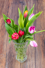 Bouquet of beautiful fresh tulips in crystal vintage vase