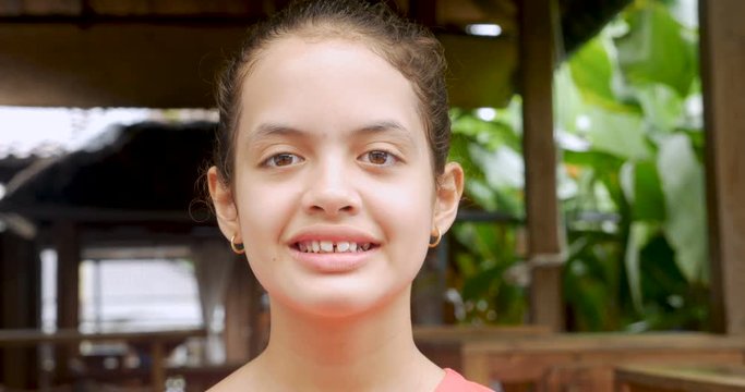 Portrait of a mixed racial 11 - 12 year old girl smiling