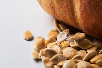 Orange pumpkin with seeds inside, close-up.