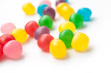 closeup of colorful round candies on white background