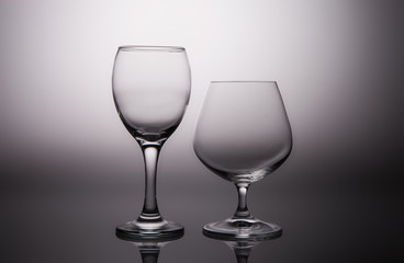 Wine and cognac glasses on a gray gradient background