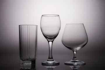 Glass transparent dishes on a gray graded background