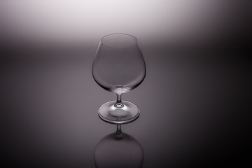 cognac glasses  on a gray graduated background