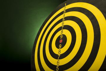 Dartboard on a green background, abstract of success - close-up.