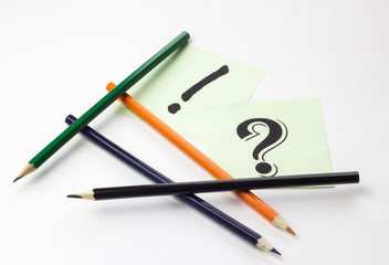 Pencils on white background with stickers and signs