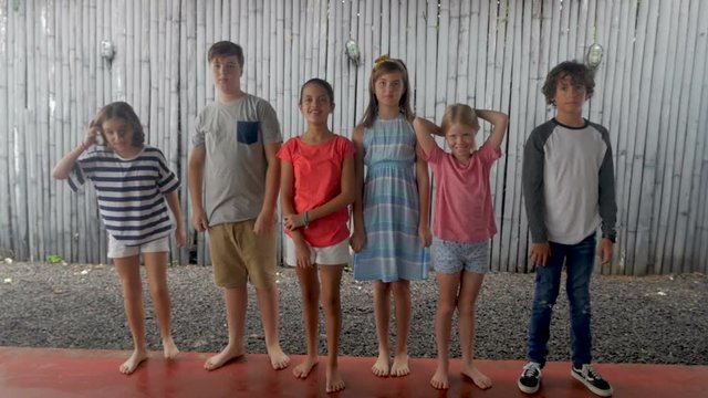 Happy diverse group of young children standing next to each other in a line