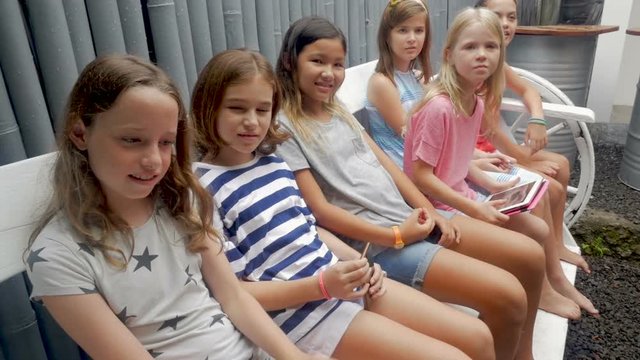 Diverse multi ethnic group of young girls sitting on a bench