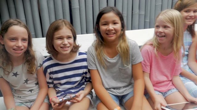Push in of a group of young girls smiling and laughing in slow motion