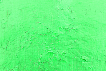 Cracked toxic green paint texture. Close-up of old painted red wall. Abstract grunge background. Vintage scratched surface