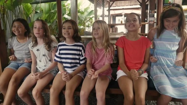 Diverse group of multi ethnic young girls celebrating and saying yes