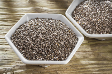 Chan beans in bowl on old wooden background (Salvia hispanica)