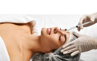 Obraz na płótnie Canvas Plastic surgery beauty concept young brunette woman face and doctor hand in glove with syringe