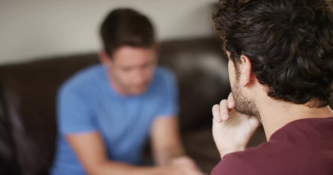 4K Male therapist in counselling session with depressed male patient. Slow motion.