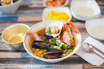 Seafood, Crab, Shrimp, Noodles in bowl. Table Setting.