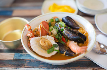 Obraz premium Seafood Soup in a Bowl. Shellfish, Shrimp, Green Onions. 