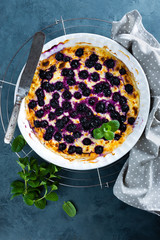 Cottage cheese casserole baked with blueberry. Curd casserole with fresh berries on kitchen table. Top view