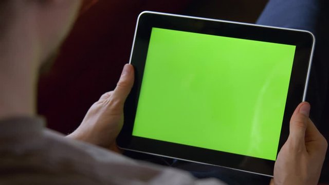 Man Using Large Tablet with Blank Chroma Green Screen