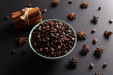 Coffee beans in a bowl with herbs and natural lighting 