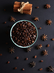 Coffee beans in a bowl with natural lighting on a black backgound