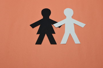 black female,white male silhouettes on orange background