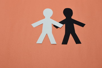 white male,black male silhouettes on orange background