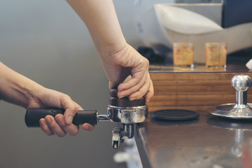 Barista crushing coffee power, preparing to make aroma hot coffee of espresso, cappuccino, latte...