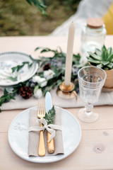 Table setting. Plate, fork and knife in rustic style