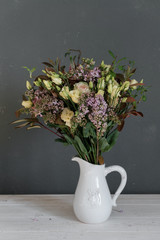 A bouquet of flowers in a jug