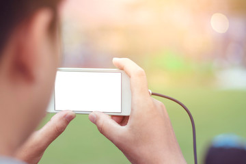 Hand holding smartphone for take photo on abstract background
