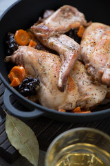 Close-up of rabbit meat stewed in white wine, selective focus, vertical shot