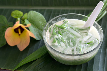 Lod Chong, dessert in sweet coconut milk Thai dessert in the glass bowl on green banana leaf. © tatui1761