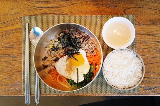 Bibimbap (Mixed meat and vegetables with rice) setting on the table at Korean restaurant 
