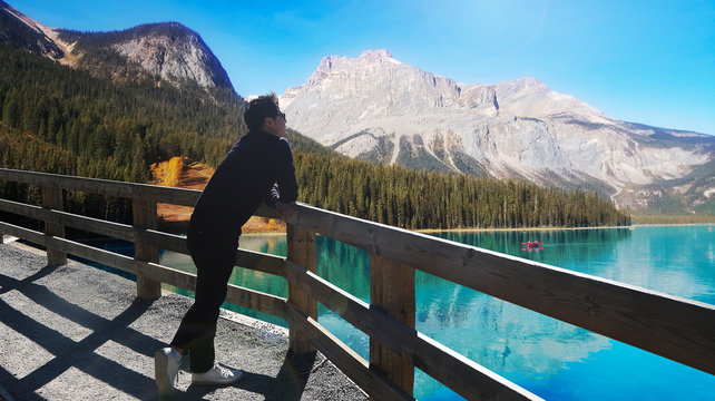 Asian man admiring beautiful lake view at Baff National Park, Canada
