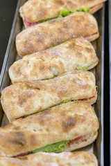 hamburger with bacon and herbs in several rows. On an iron tray