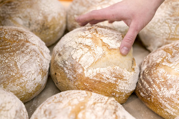 Hand reachning for bread in the store