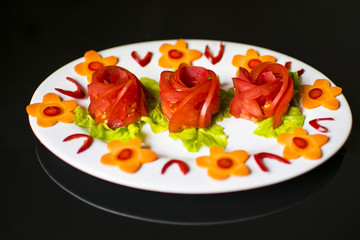 Sliced fresh chili and tomatoes with a carrot flower on top