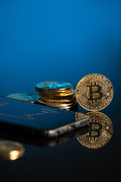 bitcoin with blue background and smartphone