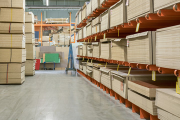 fiberboard and chipboard sheets on shelves in the building materials store.