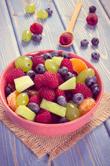 Vintage photo, Fresh fruit salad in bowl, healthy nutrition concept