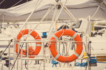 Vintage photo, Parts and detail of yacht, Orange lifebuoy on sailboat, safety travel concept