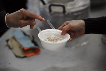 Feeding the poor to hands of a beggar. Poverty concept